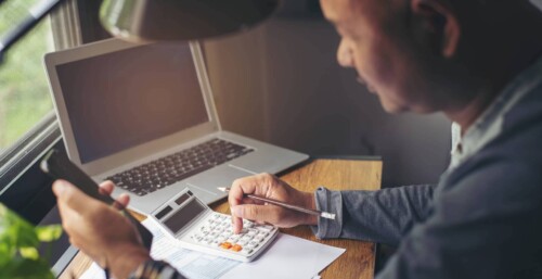 Person on calculator filing their taxes