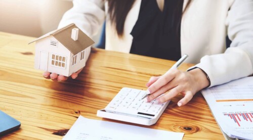 Woman Typing on Calculator