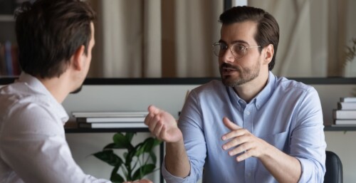 Consultant Talking to Client in Face to Face Meeting