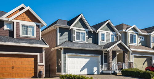 Street view of a row of neighborhood homes on a sunny day